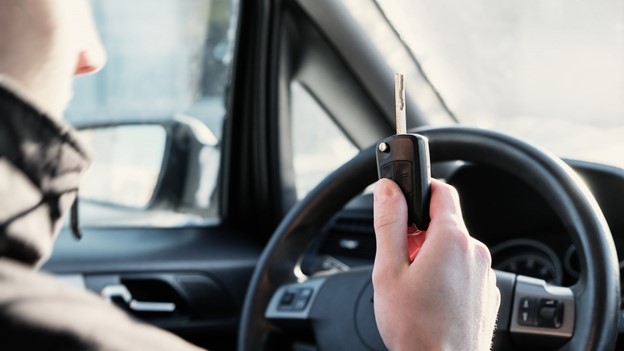 A young driver driving a car. 