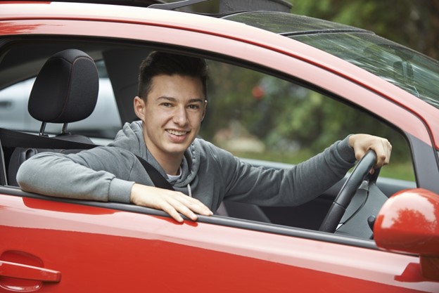 Teenage boy sitting in a car