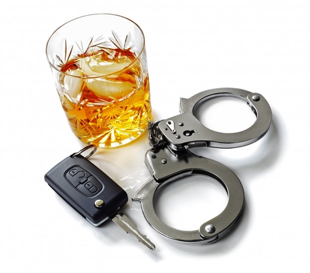 An alcoholic drink, a pair of handcuffs, and a car key